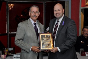 Jim Taliaferro presents 1st Annual Trey Hutchison Civilian of the Year Award to the son of the late Caddo Parish District Attorney Charles Rex Scott.